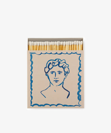 Luxury Matches: a keepsake-quality illustrated matchbox with white-tipped matches, featuring a classical head blue line drawing on the front.