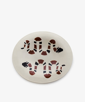 Serpent, Oval is an oval ceramic plate featuring two stylized snakes with black and brown geometric modernist patterns on a white background—ideal for fans of unique handcrafted decorative platters.
