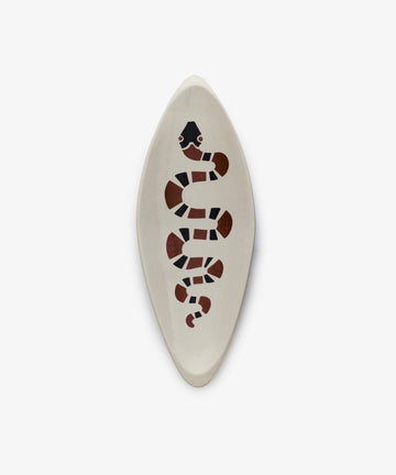 The Serpent 1, Point is a handcrafted oval ceramic dish featuring a stylized black, red, and white snake design inspired by geometric modernism, shown on a white background.