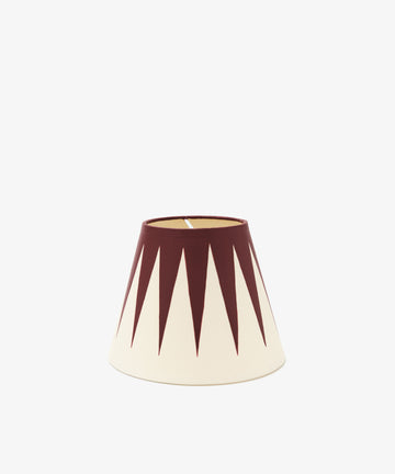 The Untitled 3 Hand-painted Lampshade features a cream-colored, conical design with dark red geometric triangular spikes pointing downward—functional artwork to enhance any space.