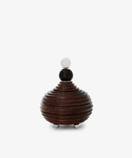 The Curiosity Box is a round, layered African wood box with a spherical lid and small metal feet, shown against a plain white background.