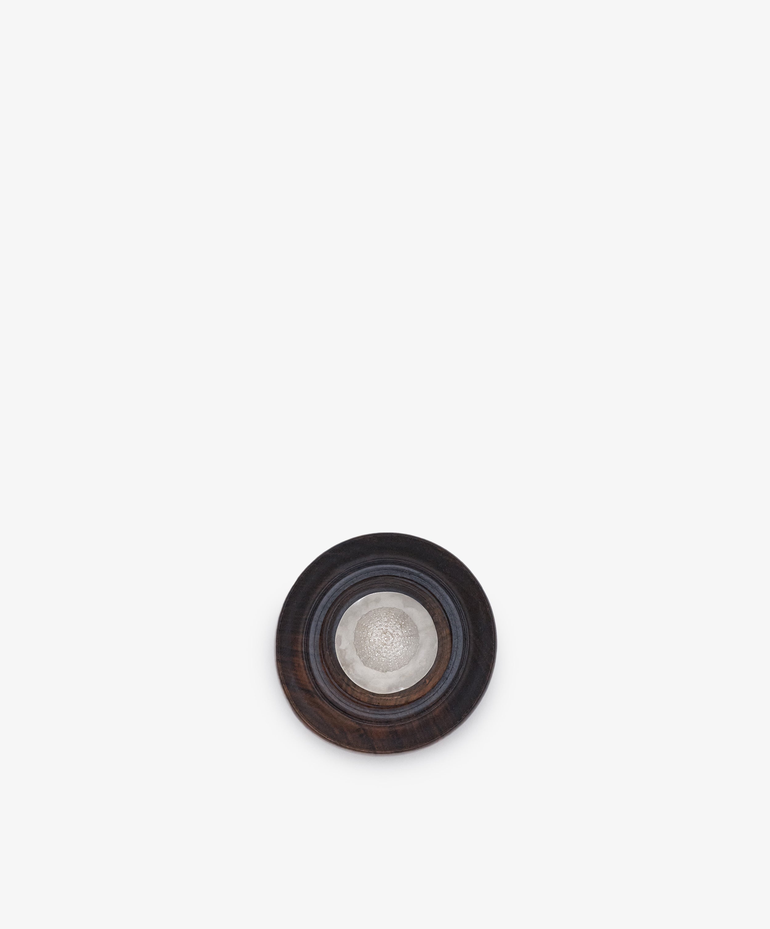 Curiosity Box 16, a round keepsake art box featuring a dark outer ring and a metallic center, is displayed against a plain white background.