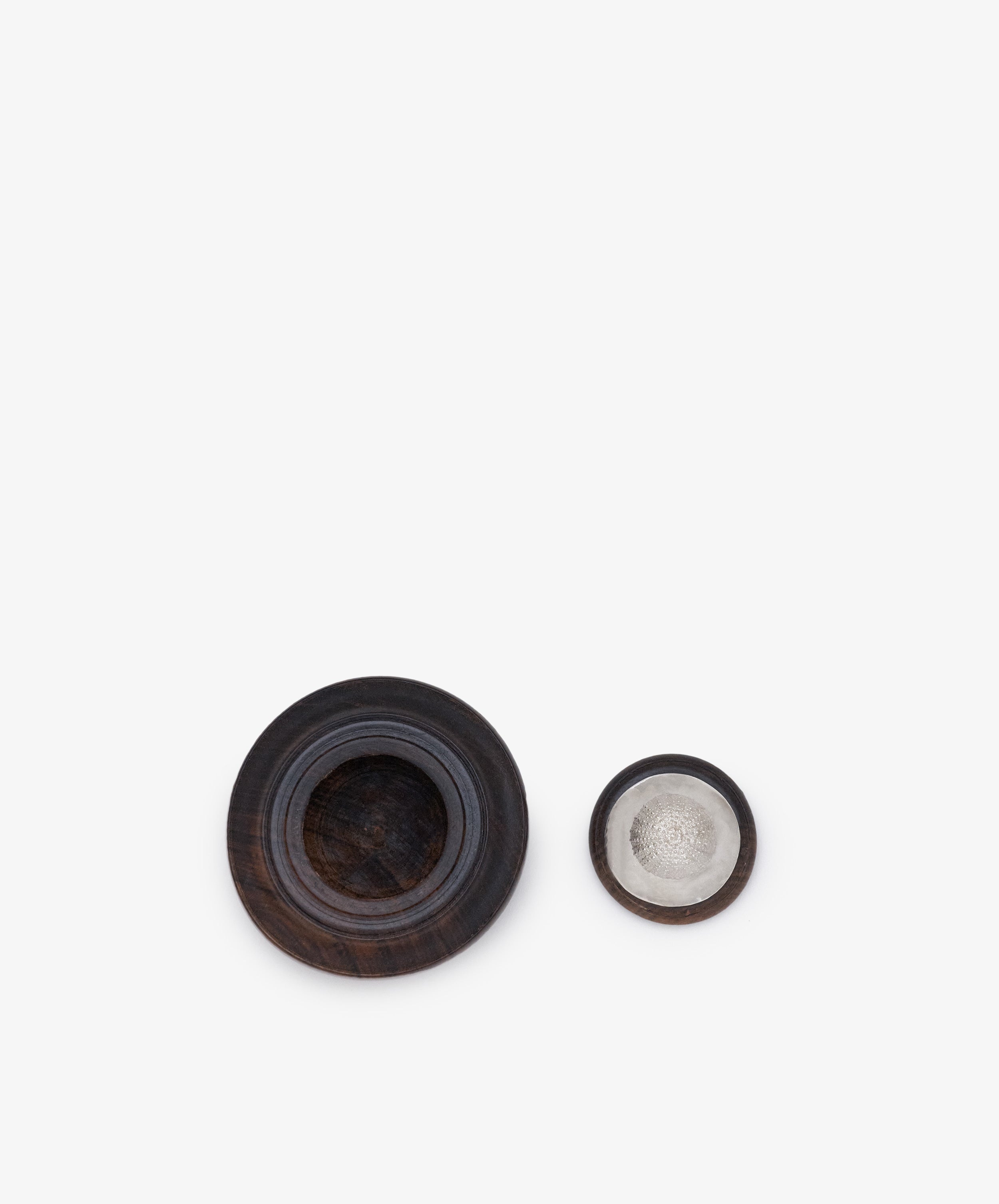 Two Curiosity Box 16 containers side by side on a white background: the left one is larger and darker, resembling African wood, while the right one is smaller with a metallic interior.