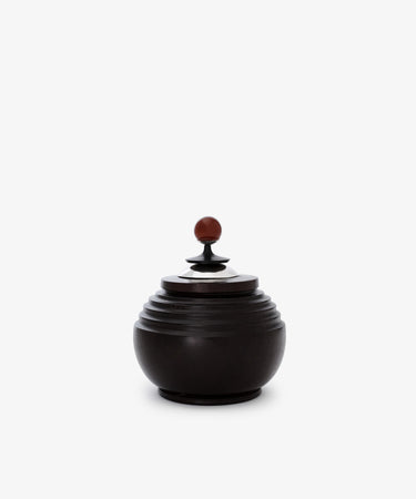 The Curiosity Box is a small, round African wood box featuring a ridged design and a matching lid with a brown spherical knob, shown on a plain white background.