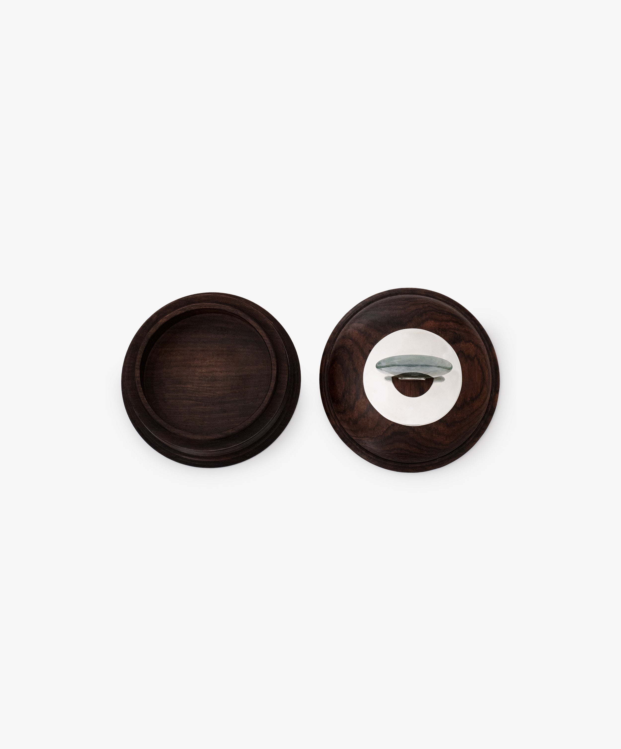 Two round dark wood Curiosity Boxes—one open with an empty base, the other closed with a metal handle—sit against a plain white background. These restored vintage keepsake boxes bring timeless elegance to any space.