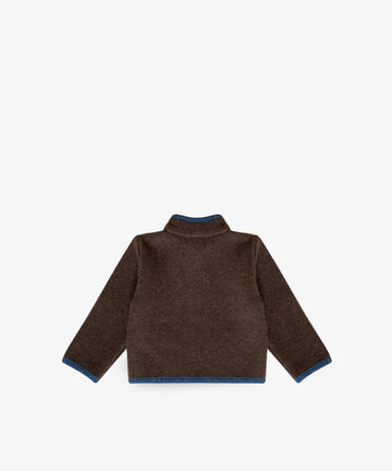 An Austrian Wool Jacket in brown merino wool with blue trim on the cuffs and hem, shown flat with the back facing up against a white background.