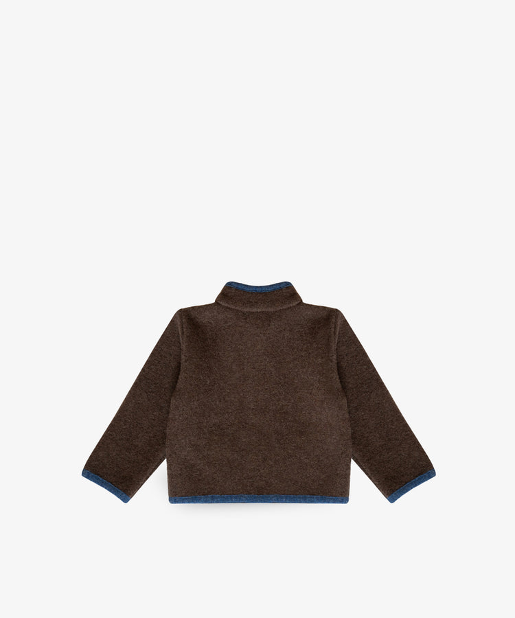 An Austrian Wool Jacket in brown merino wool with blue trim on the cuffs and hem, shown flat with the back facing up against a white background.