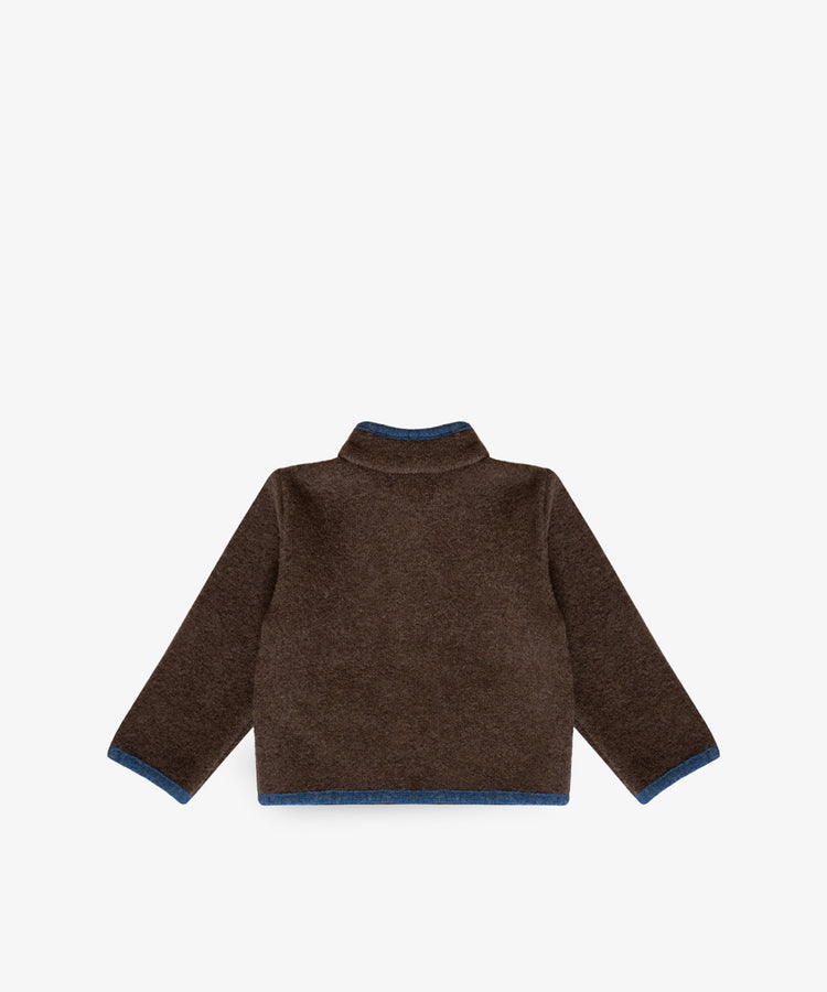 Austrian Wool Jacket in brown with blue trim on cuffs and hem, made from soft merino wool, shown flat and backward on a white background.