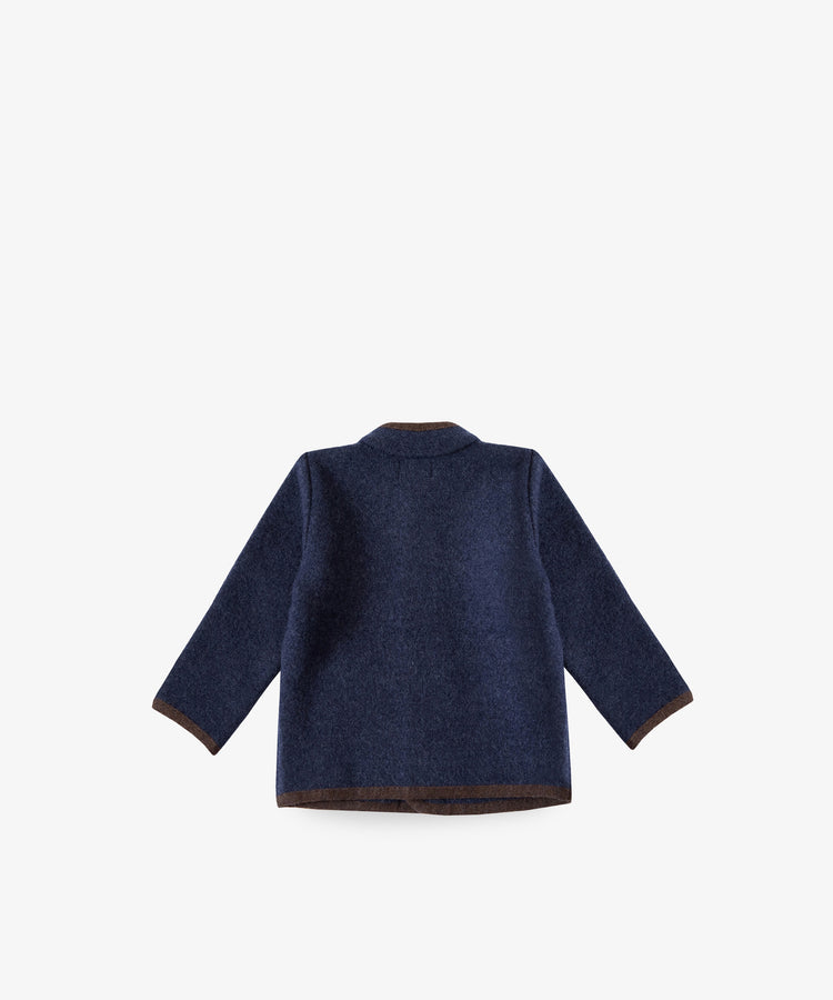 The Austrian Wool Jacket is a navy blue children’s coat with brown trim and a Nehru collar, inspired by Austrian styles, shown flat with the back facing up on a plain white background.