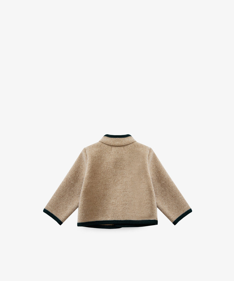 The Austrian Wool Jacket is a beige long-sleeve jacket with black trim on the collar, cuffs, and hem. It features a Nehru collar and is shown from the back against a white background.