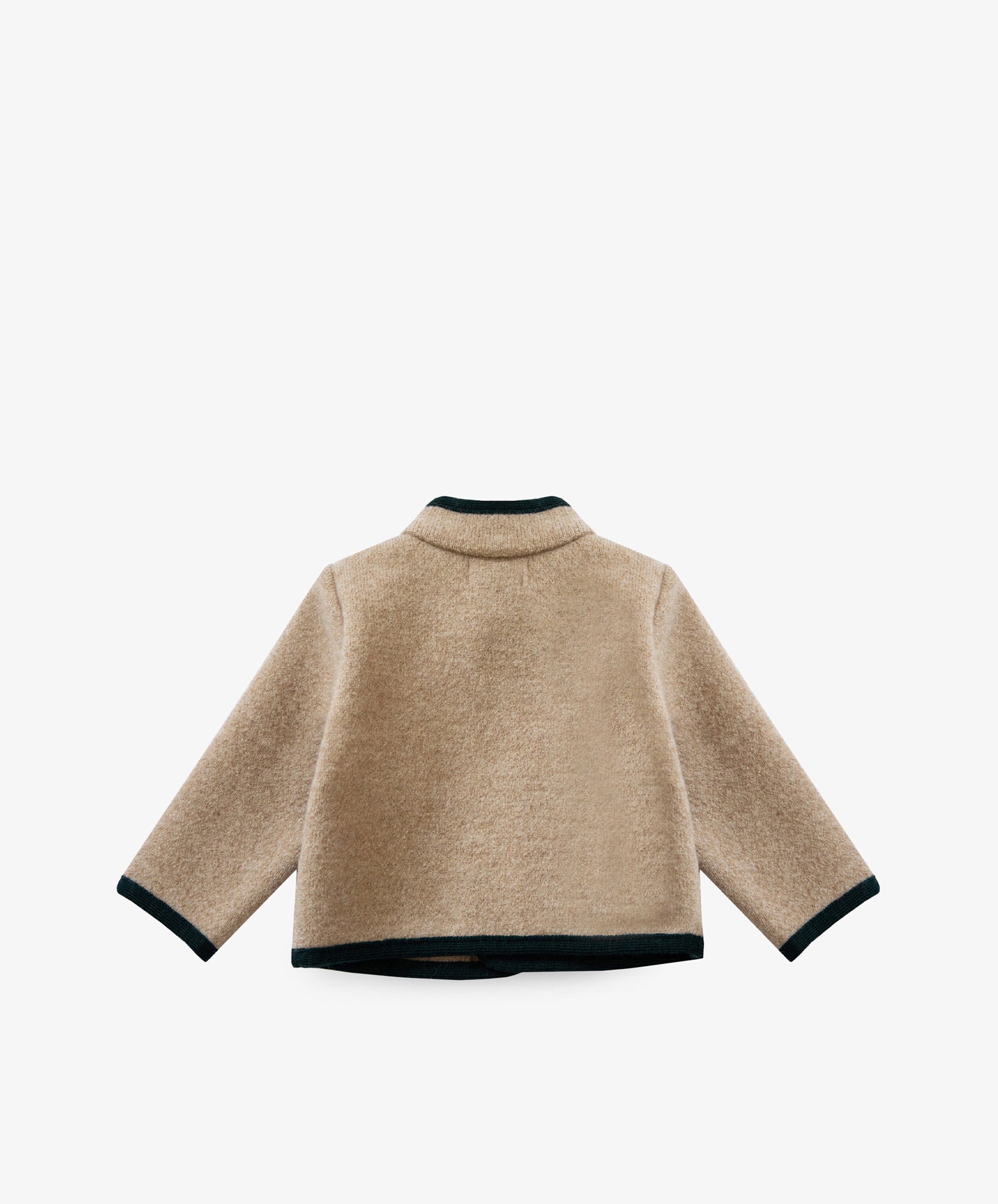 The Austrian Wool Jacket is a beige long-sleeve fleece with dark trim on the collar, cuffs, and hem, inspired by classic Austrian children’s jackets. Shown from the back against a white background.