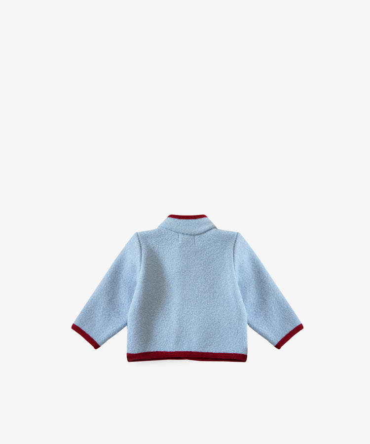 The Austrian Wool Jacket in light blue features long sleeves, a Nehru collar, and maroon trim. It is shown from the back against a plain white background.