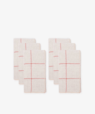 A collection of six napkins featuring a red and natural check pattern.