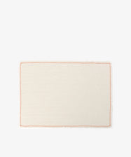 The Filial Placemat, Set of 6, features rectangular cream-colored cloth placemats with a simple orange branch stitch border, ideal for elegant tabletop decor. Shown on a plain white background.