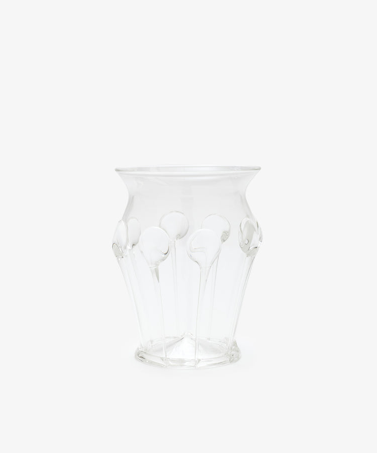 The Carlotta Vase features clear glass with a flared rim and decorative raised patterns, highlighting Bohemian artistry against a plain white background.