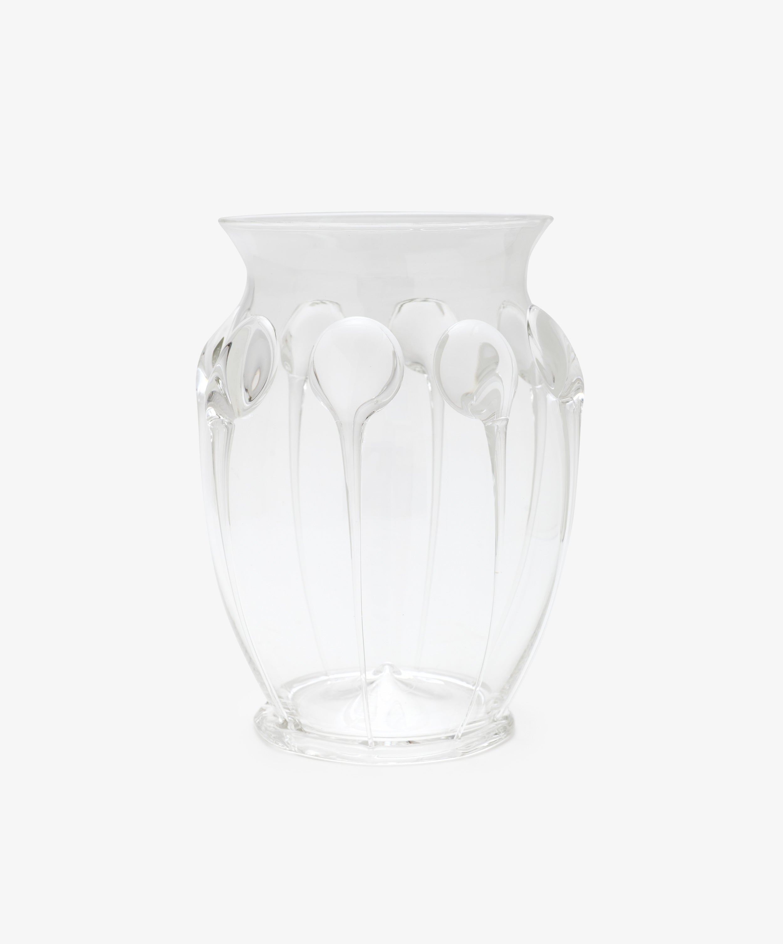 The Carlotta Vase is a clear, mouth-blown piece with a flared rim and vertical embossed patterns, set against a plain white background and highlighting Bohemian artistry.