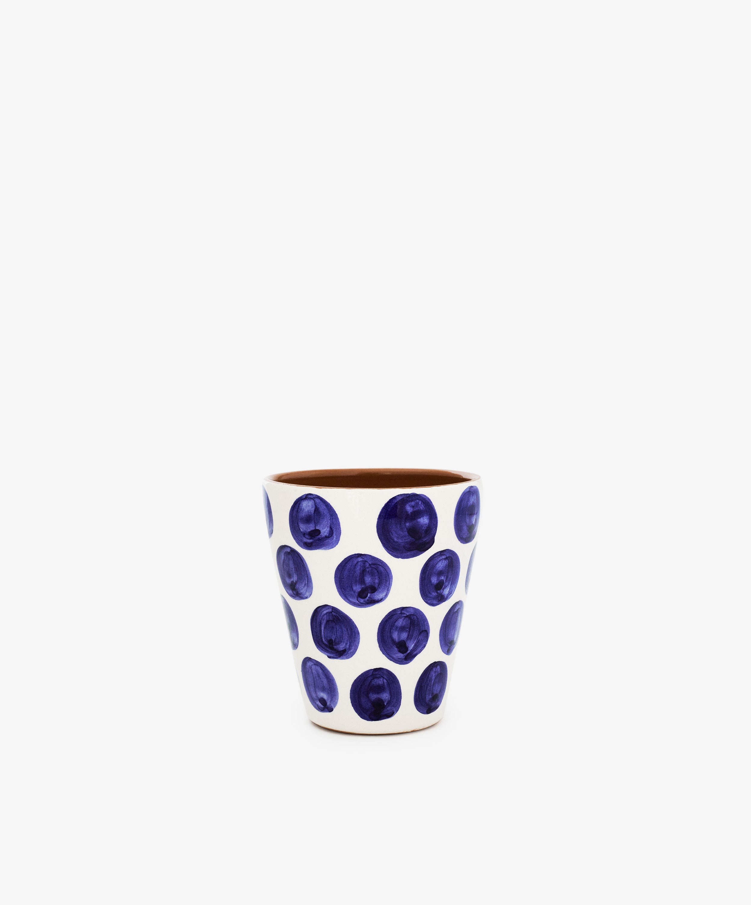 The Lula Cup, Set of 6, features white ceramic cone cups adorned with blue polka dots, beautifully capturing the charm of handmade pottery against a plain white background.