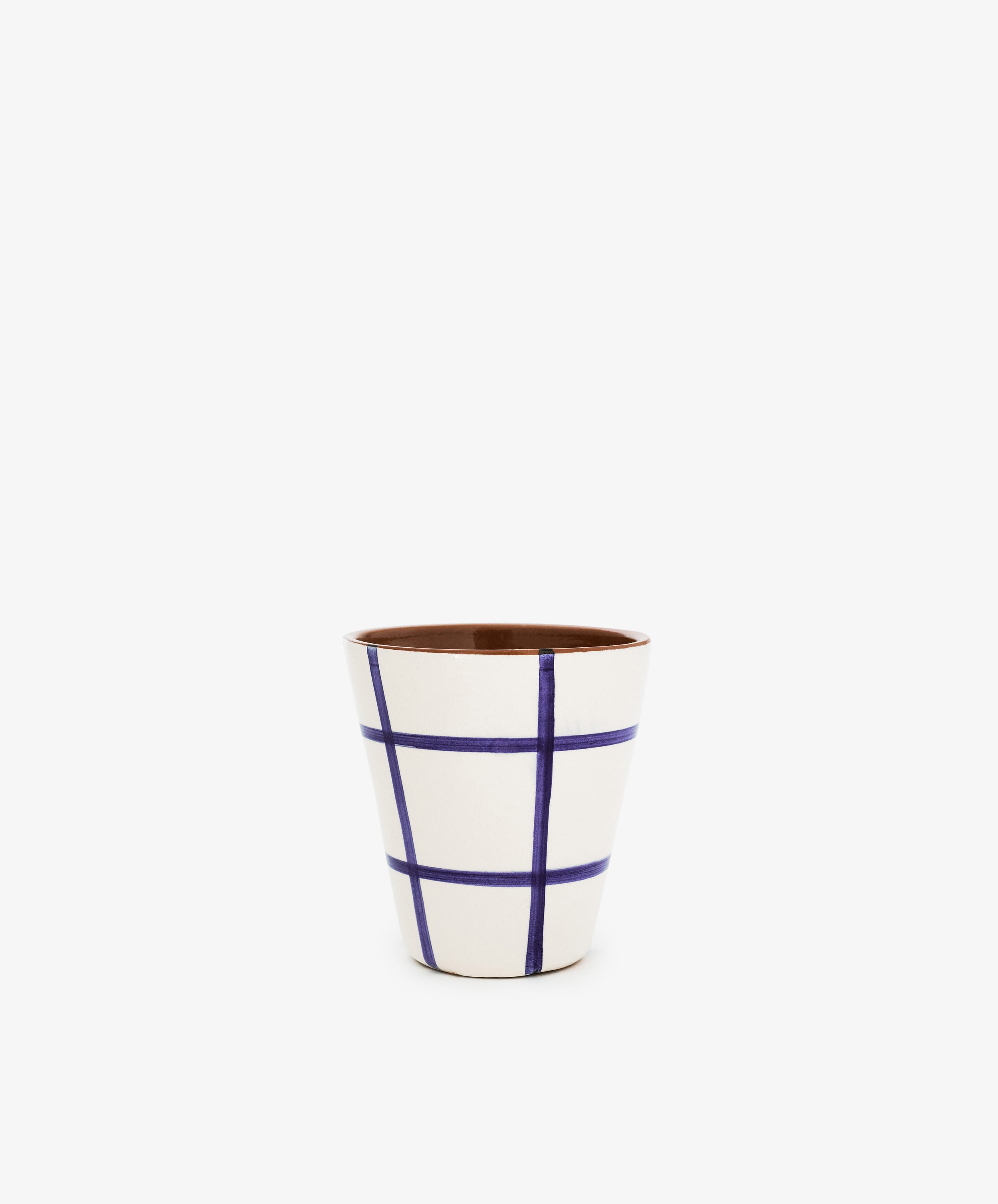 The Lula Cup, Set of 6, features white ceramic cups with a blue grid pattern and brown interior, inspired by handmade pottery styles, shown centered on a plain white background.