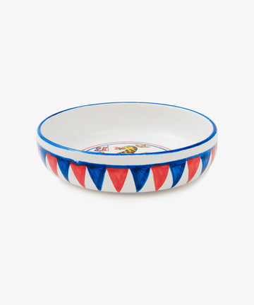 Palio Pasta Bowl in white glazed ceramic with blue and red accents and panther motif, side view.