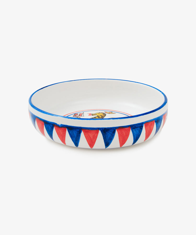 Palio Pasta Bowl in white glazed ceramic with blue and red accents and panther motif, side view.