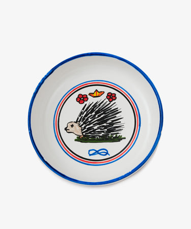 Palio Pasta Bowl in white glazed ceramic with blue and red accents and porcupine motif. 