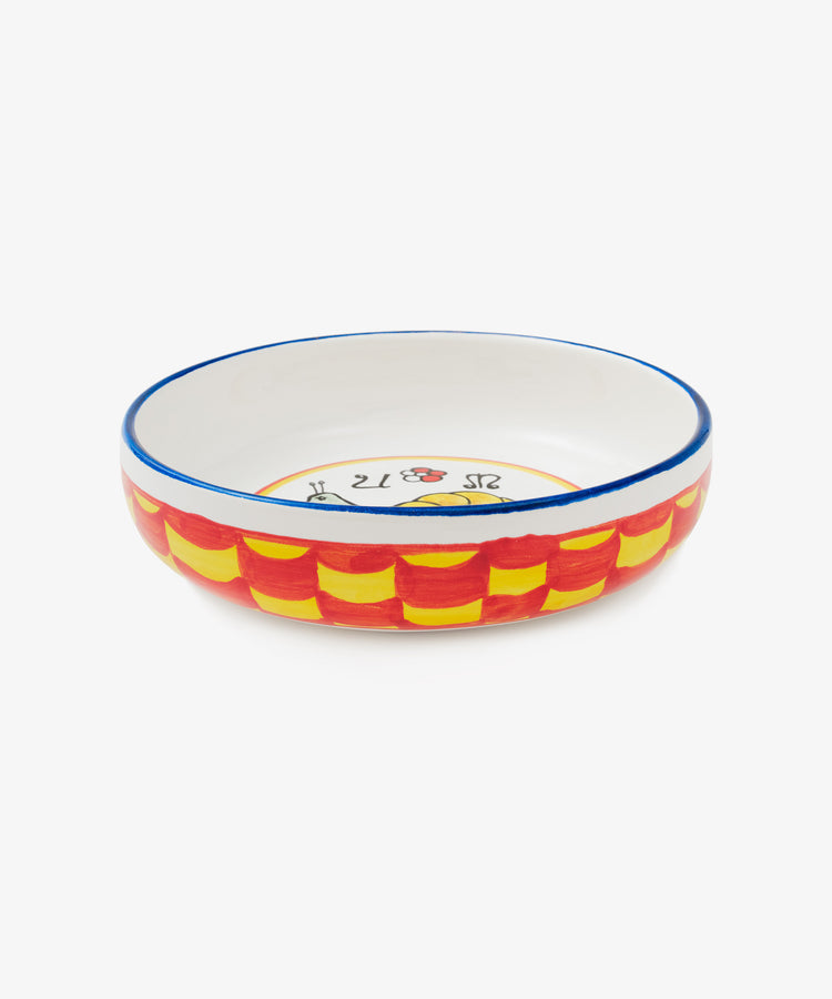 Palio Pasta Bowl in white glazed ceramic with blue and yellow accents and snail motif, side view.