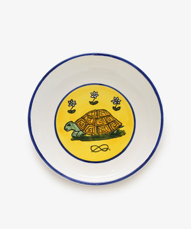 Palio Pasta Bowl in white glazed ceramic with blue and yellow accents and tortoise motif.