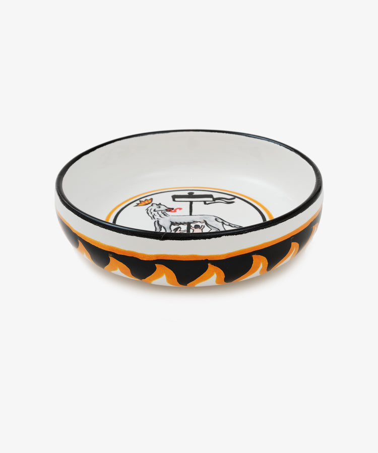 Palio Pasta Bowl in white glazed ceramic with black and orange accents and wolf motif, side view.