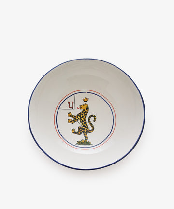 Palio Serving Bowl. Large white glazed ceramic bowl with red and blue accents and panther motif. 
