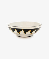 Palio Serving Bowl. Large white glazed ceramic bowl with black and orange accents, side view.