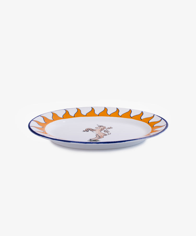 Palio Serving Platter. Glazed ceramic oval plate in orang and blue designs with unicorn motif, side view.