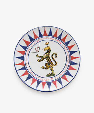Palio Round Serving Platter. Large white glazed ceramic plate with red and blue accents and panther motif. 