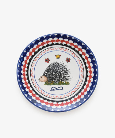 Palio Round Serving Platter. Large white glazed ceramic plate with blue and red accents and porcupine motif. 
