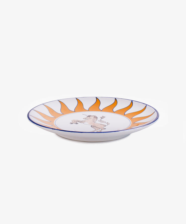 Palio Round Serving Platter. Large white glazed ceramic plate with orange and blue accents, side view.