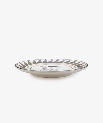 Palio Round Serving Platter. Large white glazed ceramic plate with black and orange accents, side view.