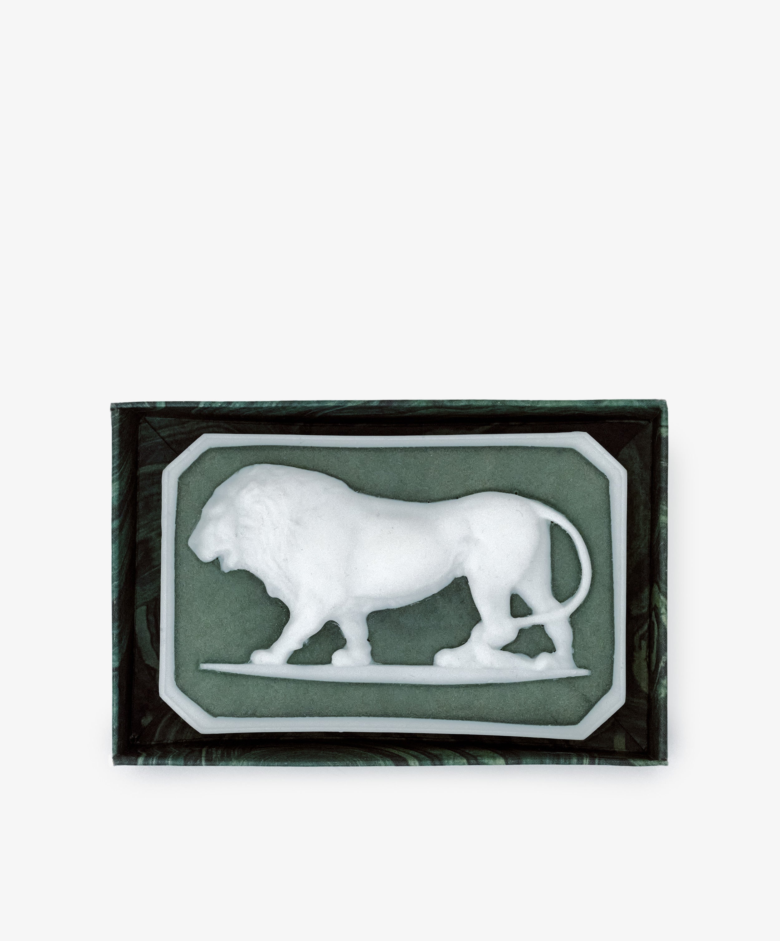 The Ancient Lion Soap, a sculptural lion-shaped bar, is presented in a rectangular box featuring a dark green interior.