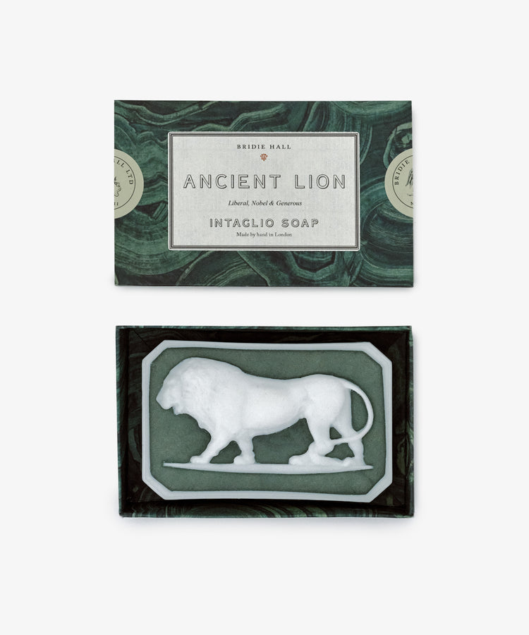 A box labeled Ancient Lion Soap showcases a sculptural bar with a white lion relief, set against a green and black marble-patterned background.