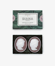 A Diana Soap, Set of 2 box holds two oval soaps, each intaglio-carved with white cameo profiles on a dark base and delicately scented with cardamom mimosa fragrance.
