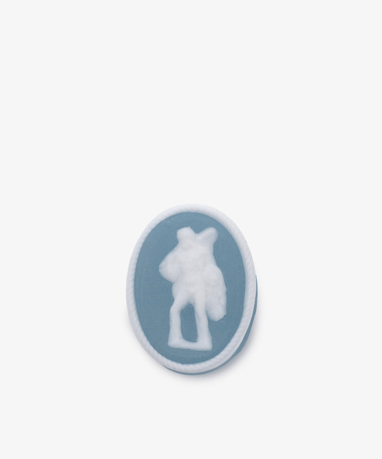 A blue soap from the Grand Tour Collection of Intaglio Soaps, Set of 5, features a white silhouette of a person carrying an object, cameo-style, on a plain white background.