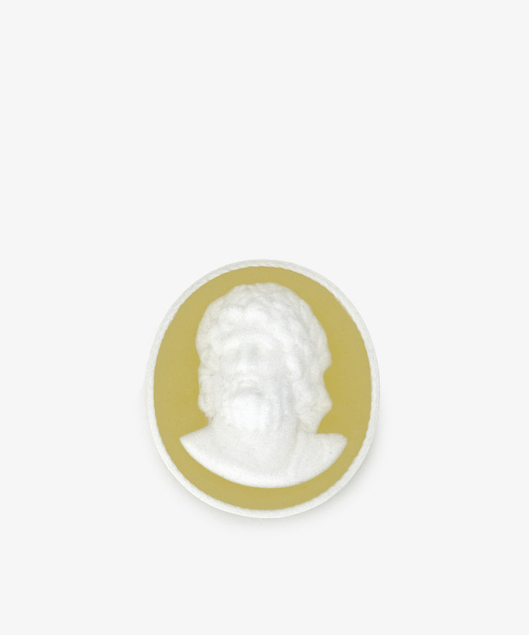 A round Hercules Soap featuring a white cameo relief of a bearded man's head and shoulders, set on a yellow background against a plain light surface.