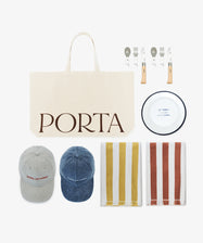 The Pesco Weekender, featuring a beige canvas tote labeled PORTA, two caps, a picnic set with metal plate and cutlery, and two striped cotton towels, is arranged on a white background.
