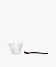 Two clear bowls from the Sweet Treat Bundle are stacked together beside a dark Lungo spoon and fork, all set on a plain white background—ideal for assembling your own Valentine’s Day bundle.