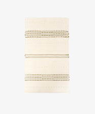 The Gaia Floor Mat is a rectangular, cream-colored rug featuring textured horizontal brown stripes and a minimalist design, handwoven from recycled fabric and shown on a plain white background.
