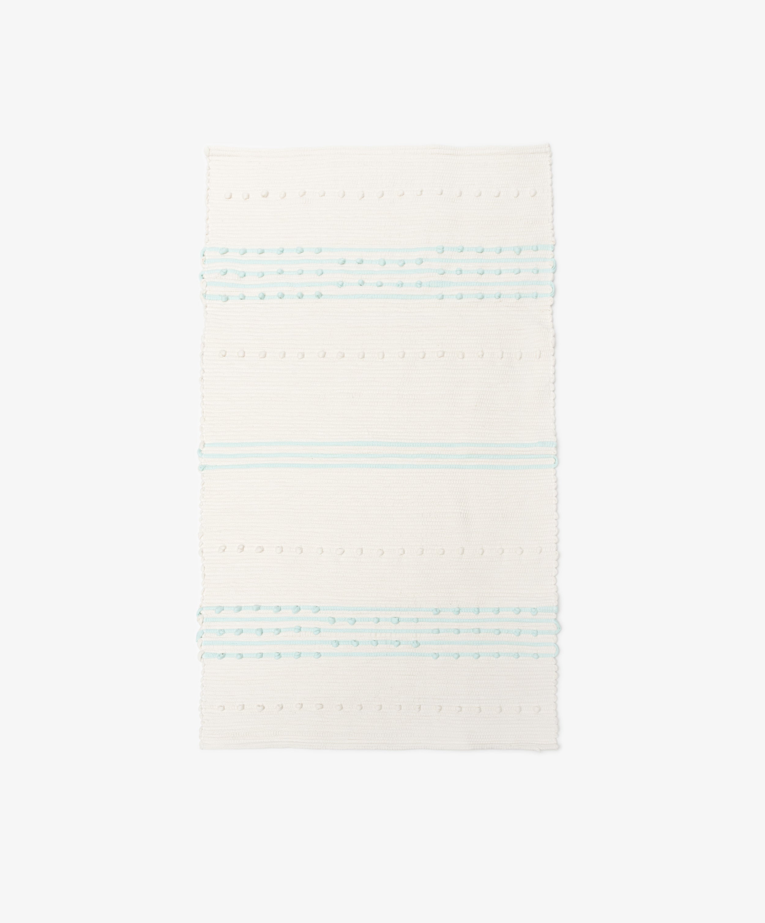 The Gaia Floor Mat is a rectangular white rug inspired by Portuguese tradition, with horizontal pale blue stripes and dotted texture—handwoven from recycled fabric for a unique look.