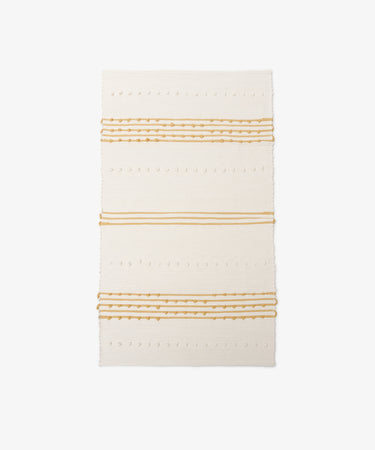 Gaia Floor Mat: A rectangular off-white rug with horizontal mustard yellow stripes and dotted textured patterns, handwoven from recycled fabric in the spirit of Portuguese tradition, shown on a white background.