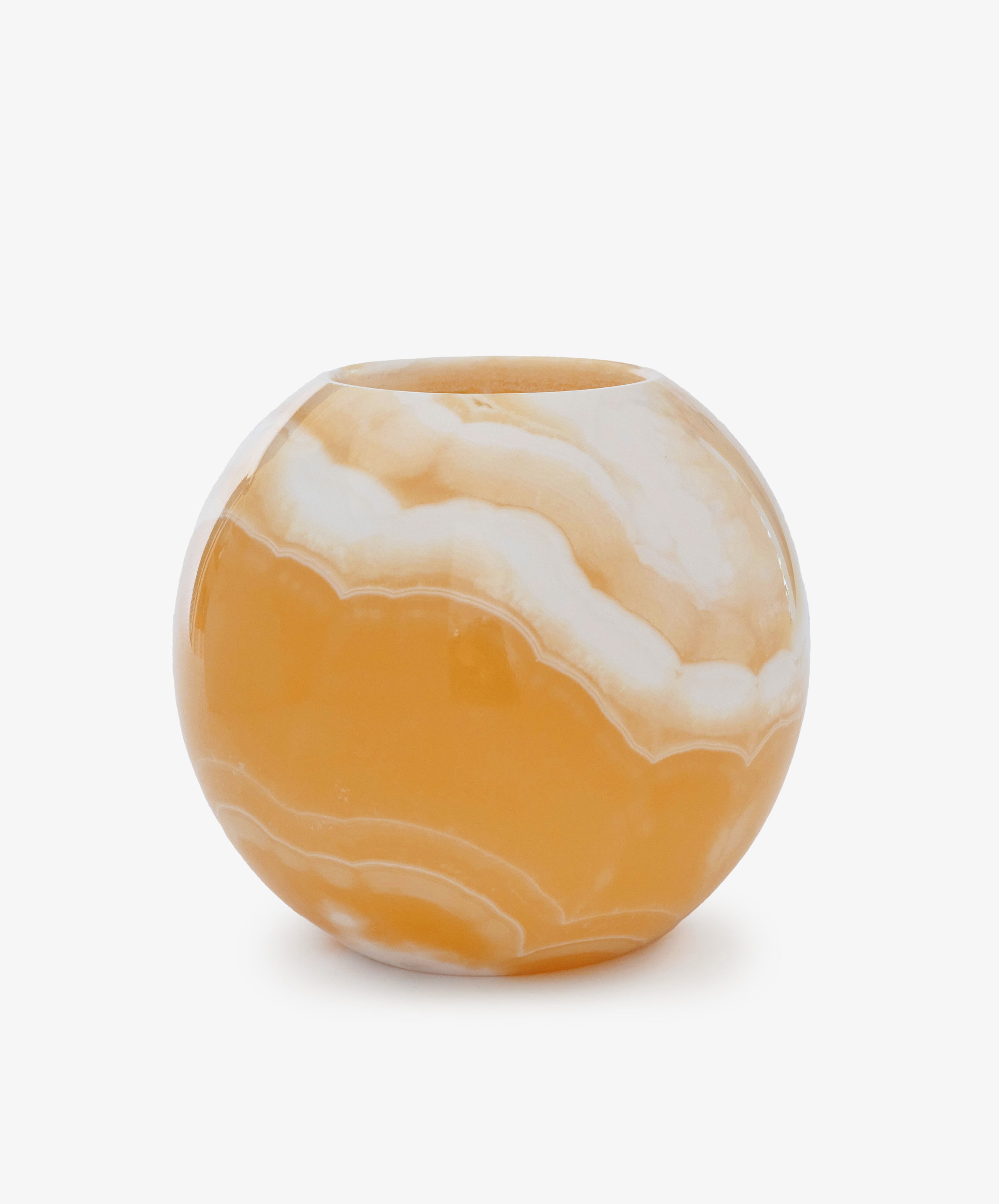 The Akila Candleholder is a round vase with a glossy marbled orange and white finish, inspired by handcrafted Egyptian Alabaster, shown against a plain white background.
