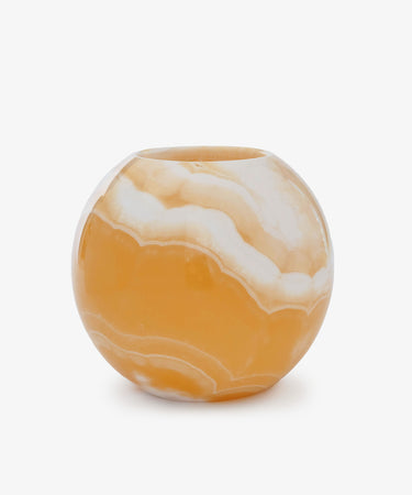 The Akila Candleholder is a round vase with a glossy marbled orange and white finish, inspired by handcrafted Egyptian Alabaster, shown against a plain white background.
