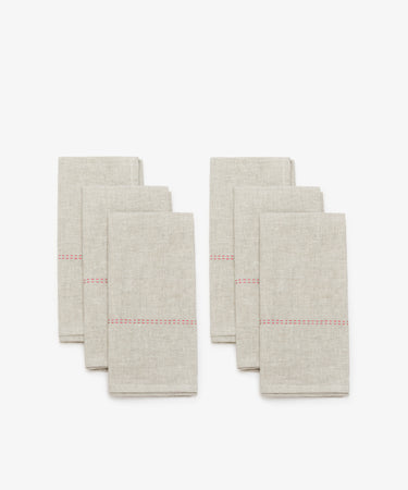 Rythmo Linen Napkins. Two rows of three natural linen napkins with small red stitching detail.