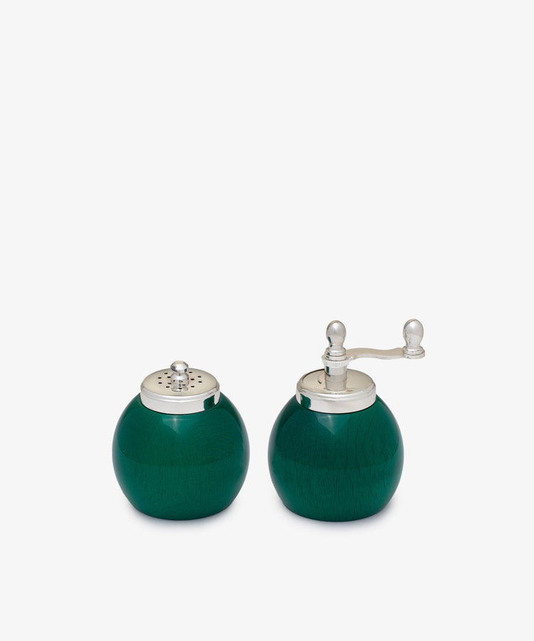 The Theo Pepper Mill and Salt Shaker, made from painted wood with metal handles in matching green, display elegant Italian design as they sit side by side on a white background.