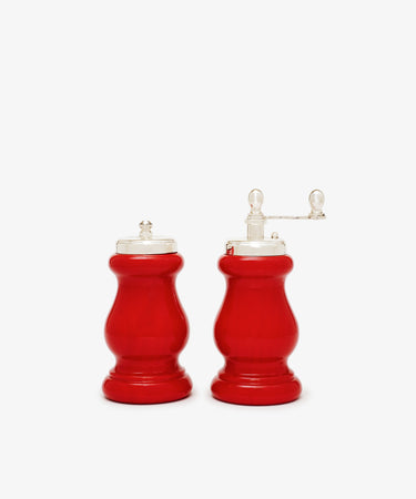 The Giorgia Pepper Mill and Salt Shaker set includes two red, wooden mills with silver tops—one handled pepper grinder and one handleless salt shaker—boasting Italian design and a premium grinding mechanism, shown on a white background.